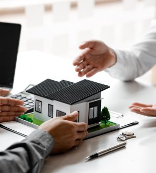 Real estate agents explain models of housing estates in projects.